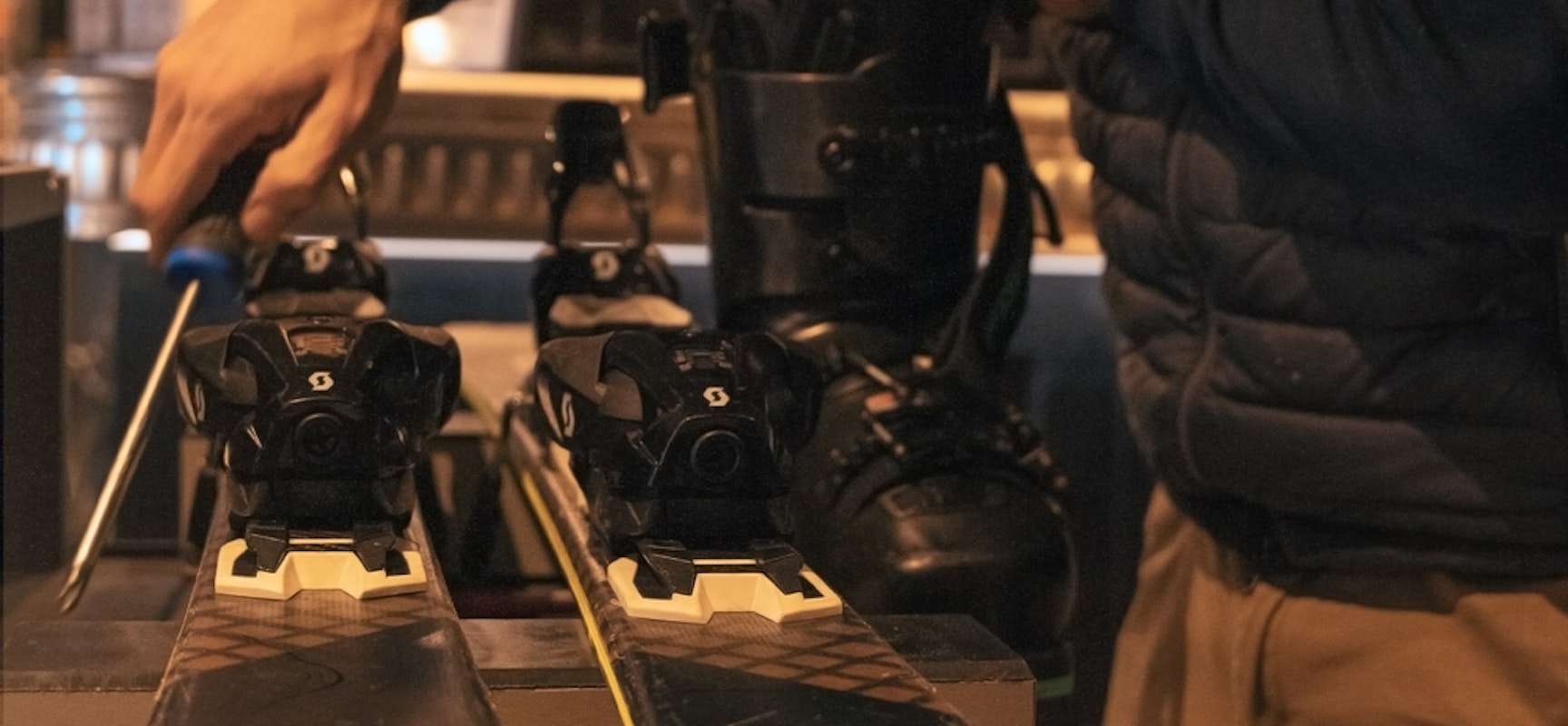 Close-up of alpine skis being set up and calibrated for optimal performance on the snow