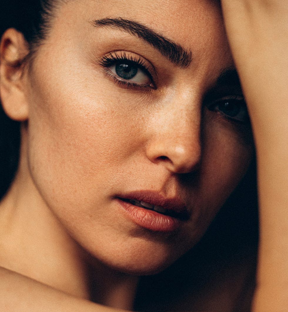 woman holding head and posing for picture