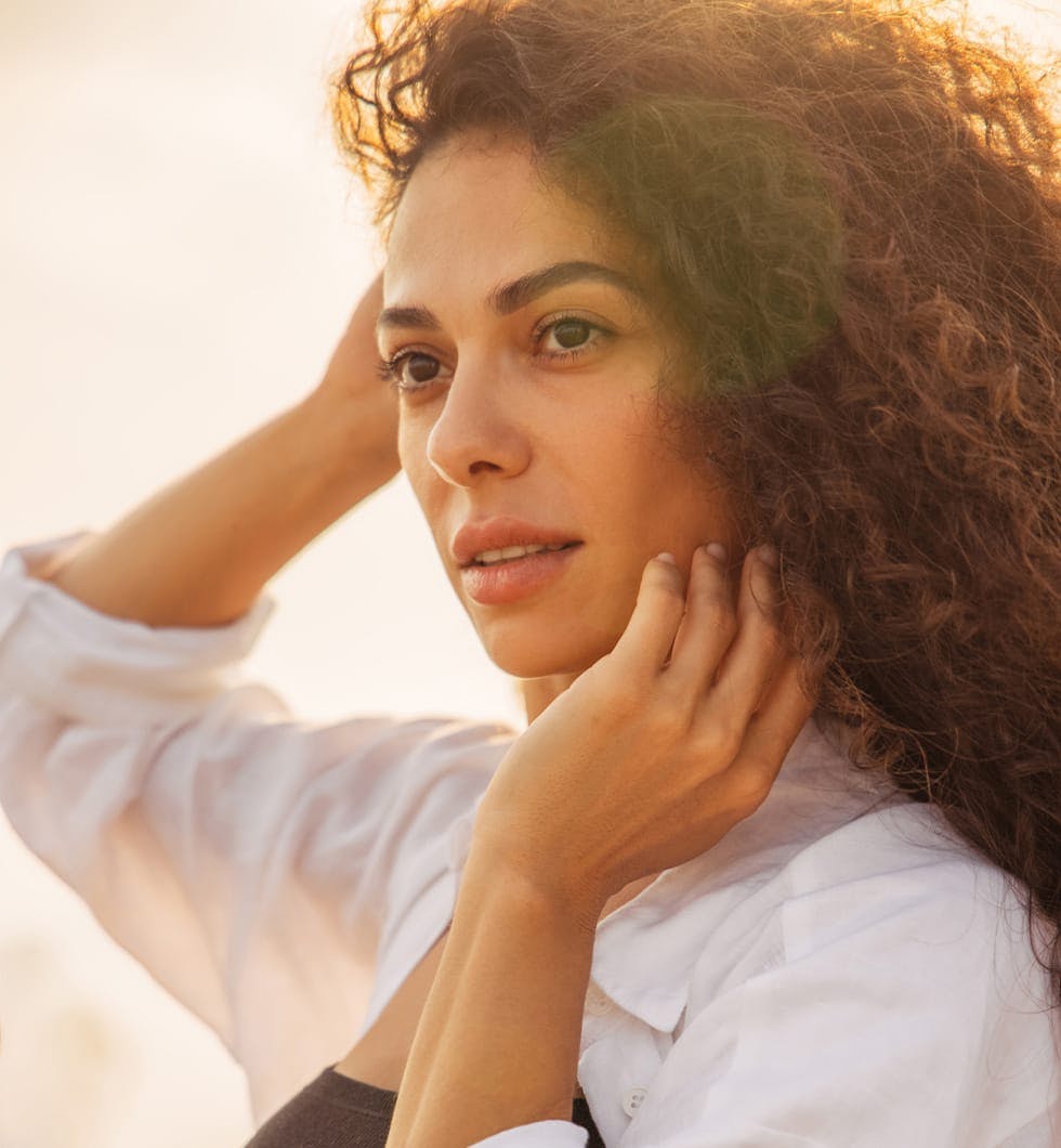 woman with long hair and a white shirt