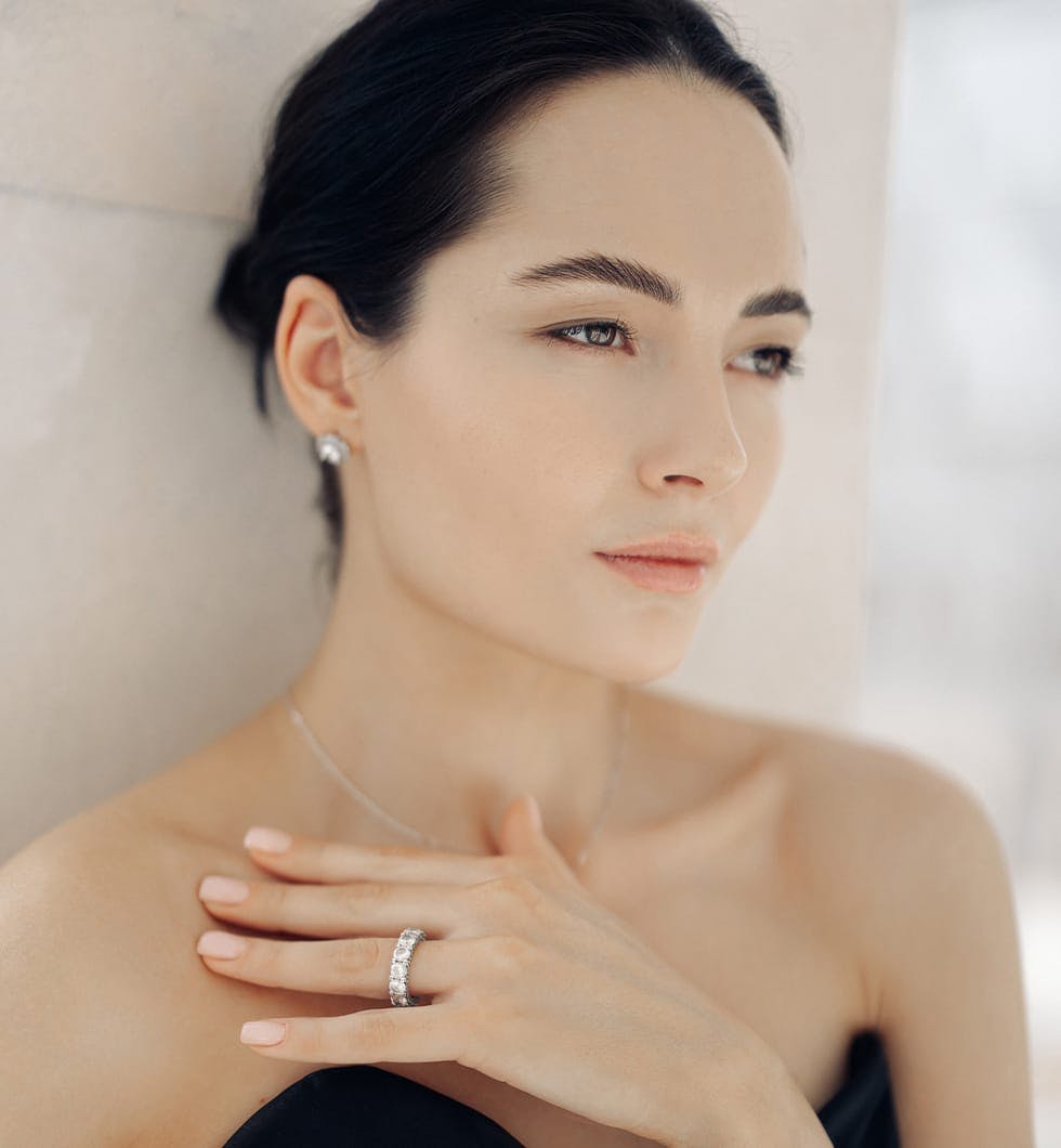 woman with a black dress and a diamond ring
