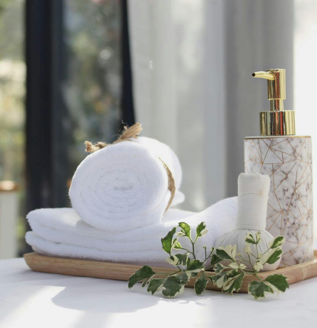 towels and lotion on a tray