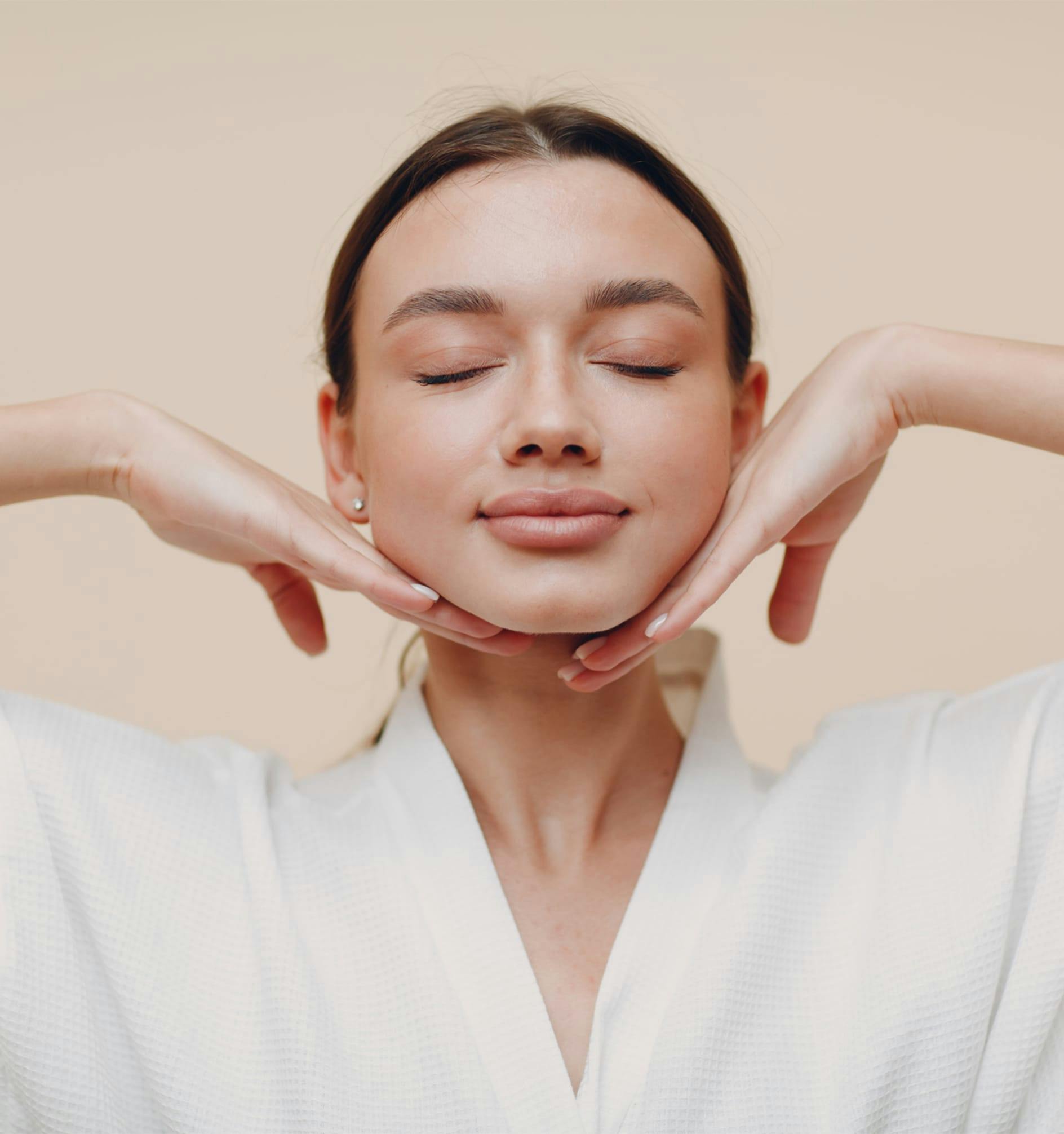 woman touching her face with her hands