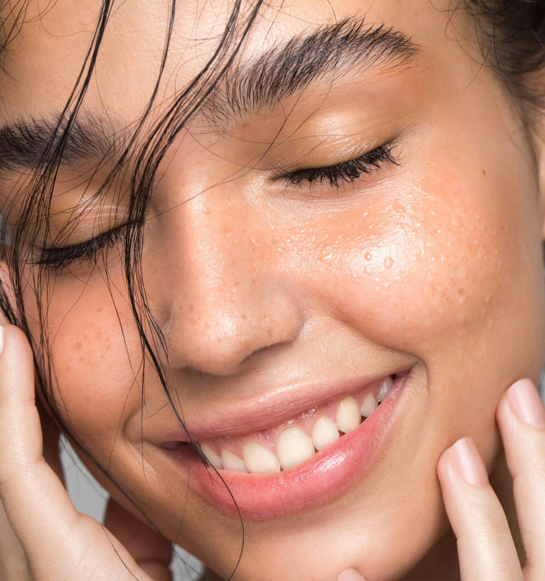 woman touching face with her hand