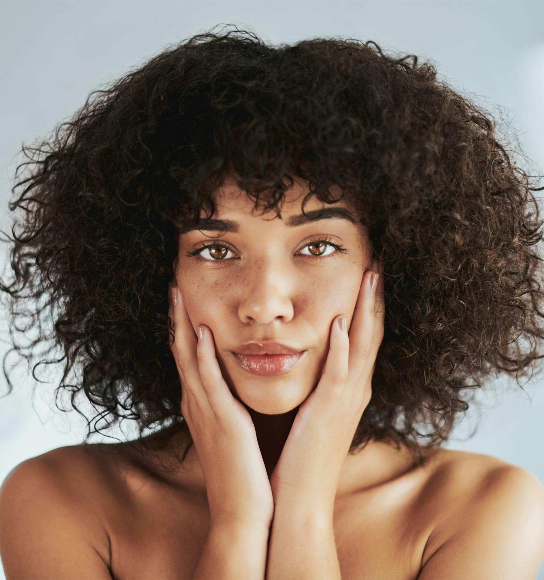 woman cupping her face in her hands