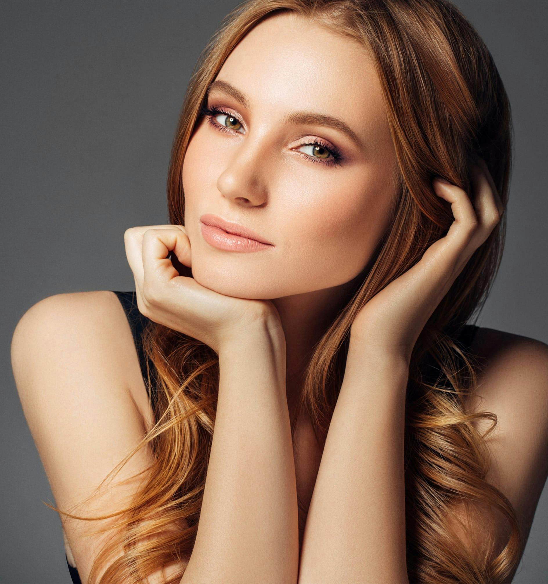 woman with hands by her face
