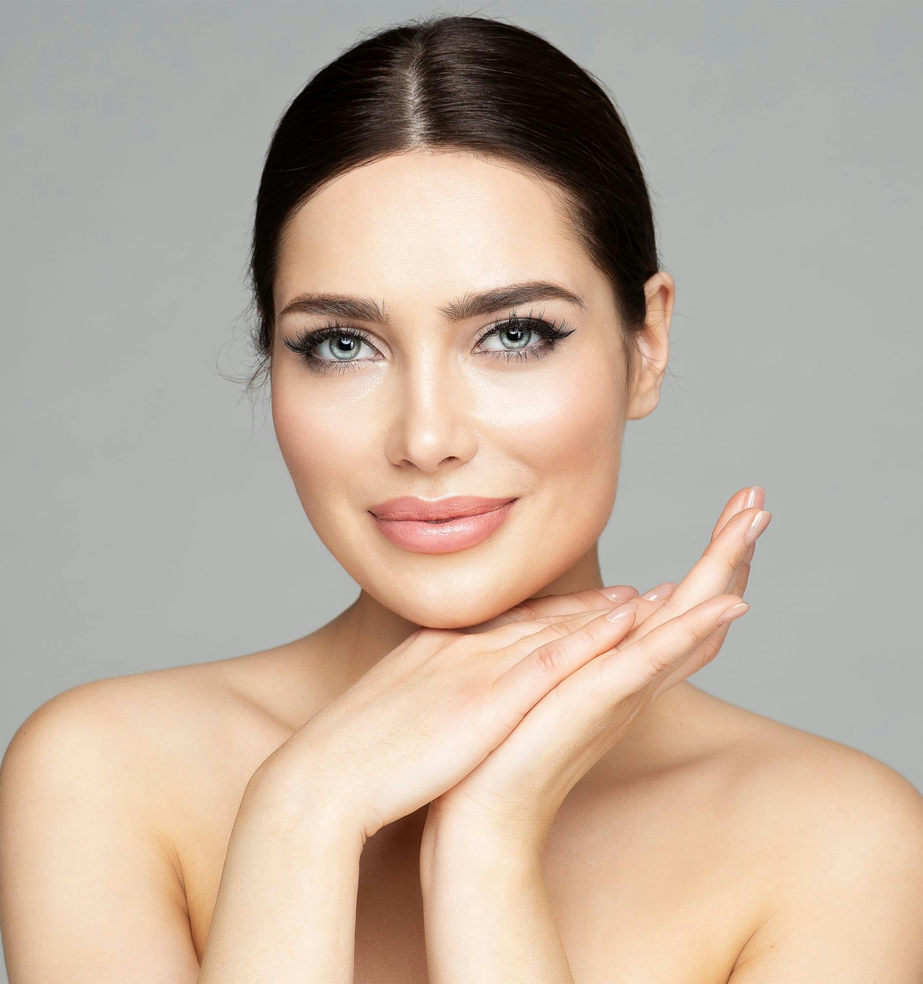 woman with hands by her face