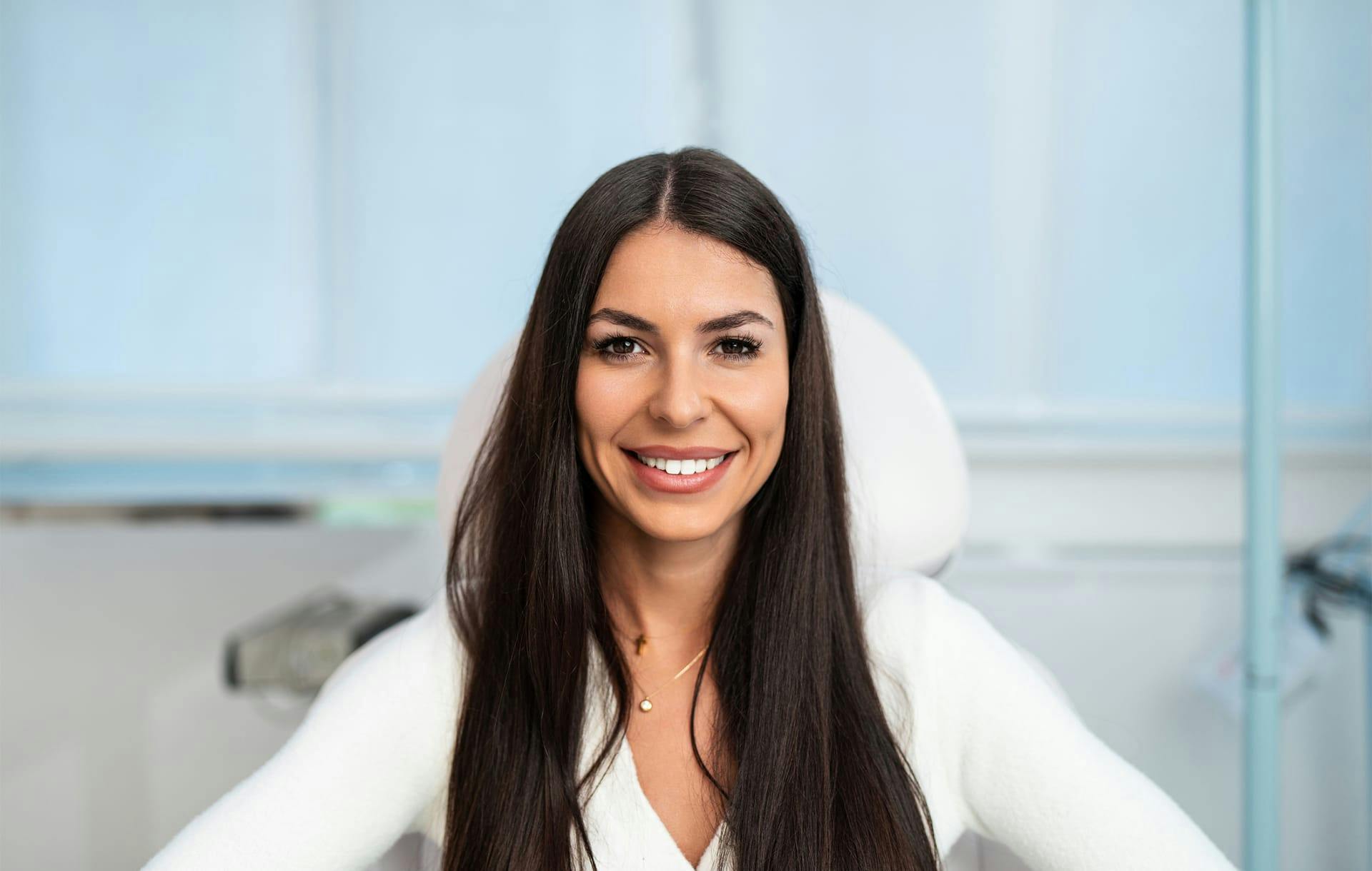 woman with long brown hair smiling
