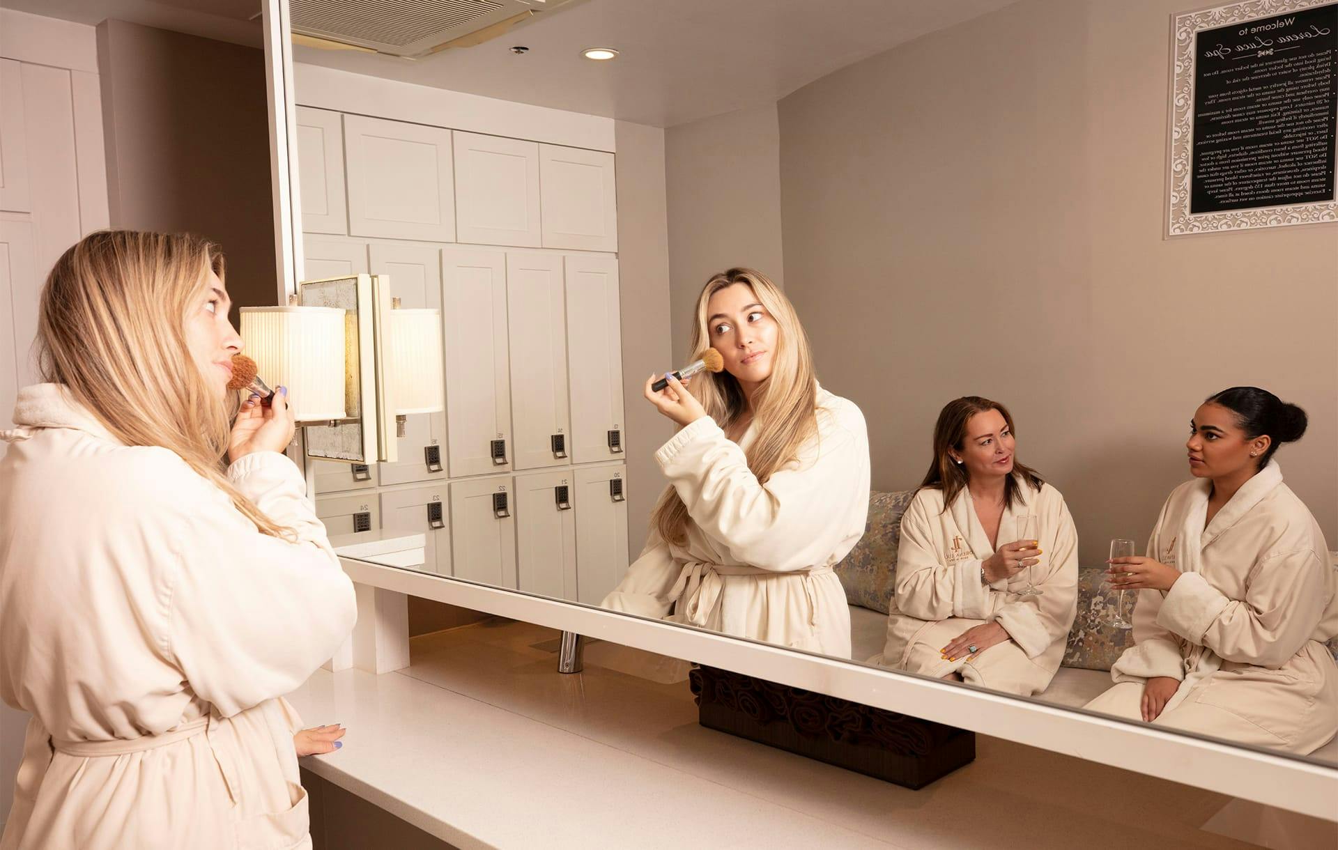woman in robes in a locker room