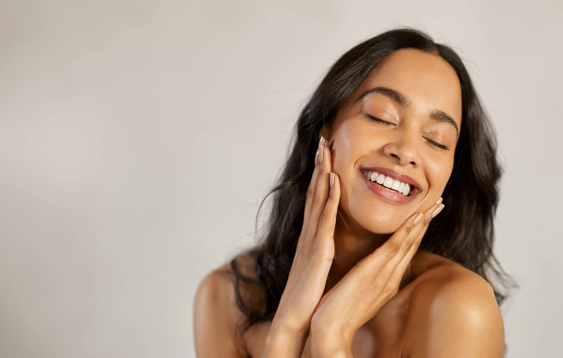 woman cupping her face in her hands