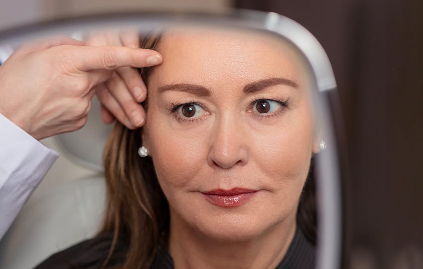 woman looking in mirror