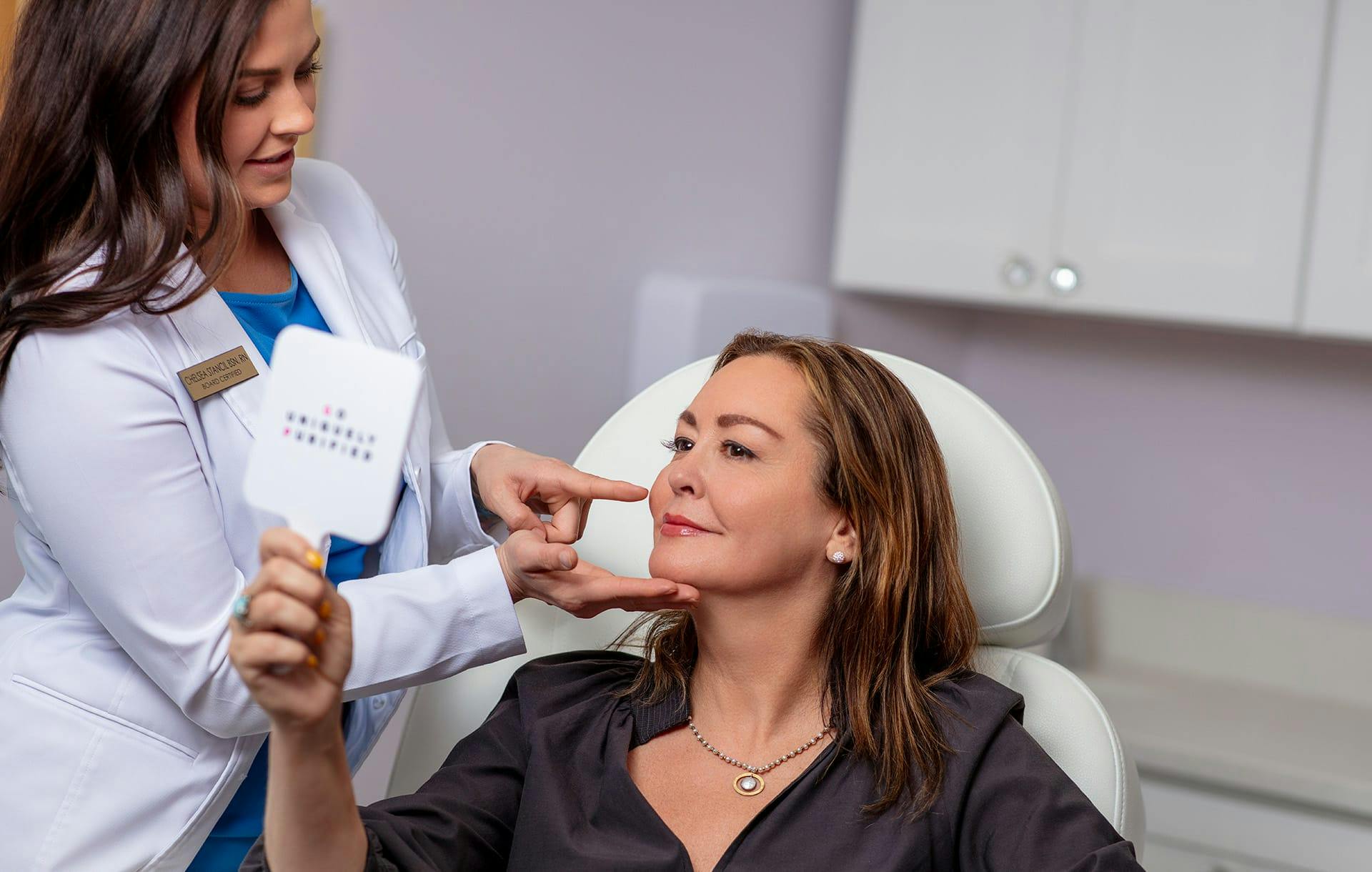 provider touching patient's face while patient looks in mirror