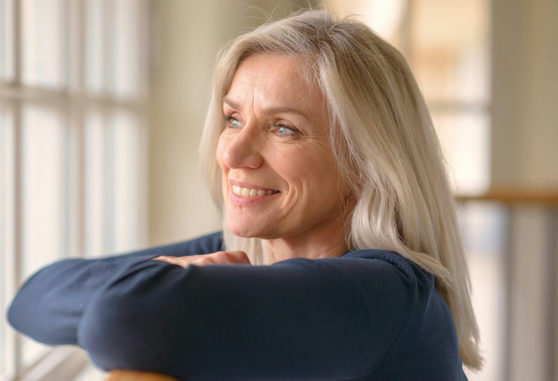 Woman looking out the window and smiing