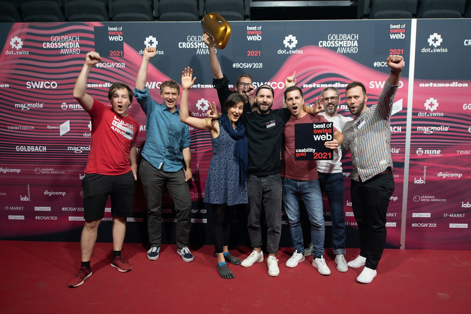 Eine Gruppe Menschen vor der Best of Swiss Web Sponsorenwand während der Siegerehrung