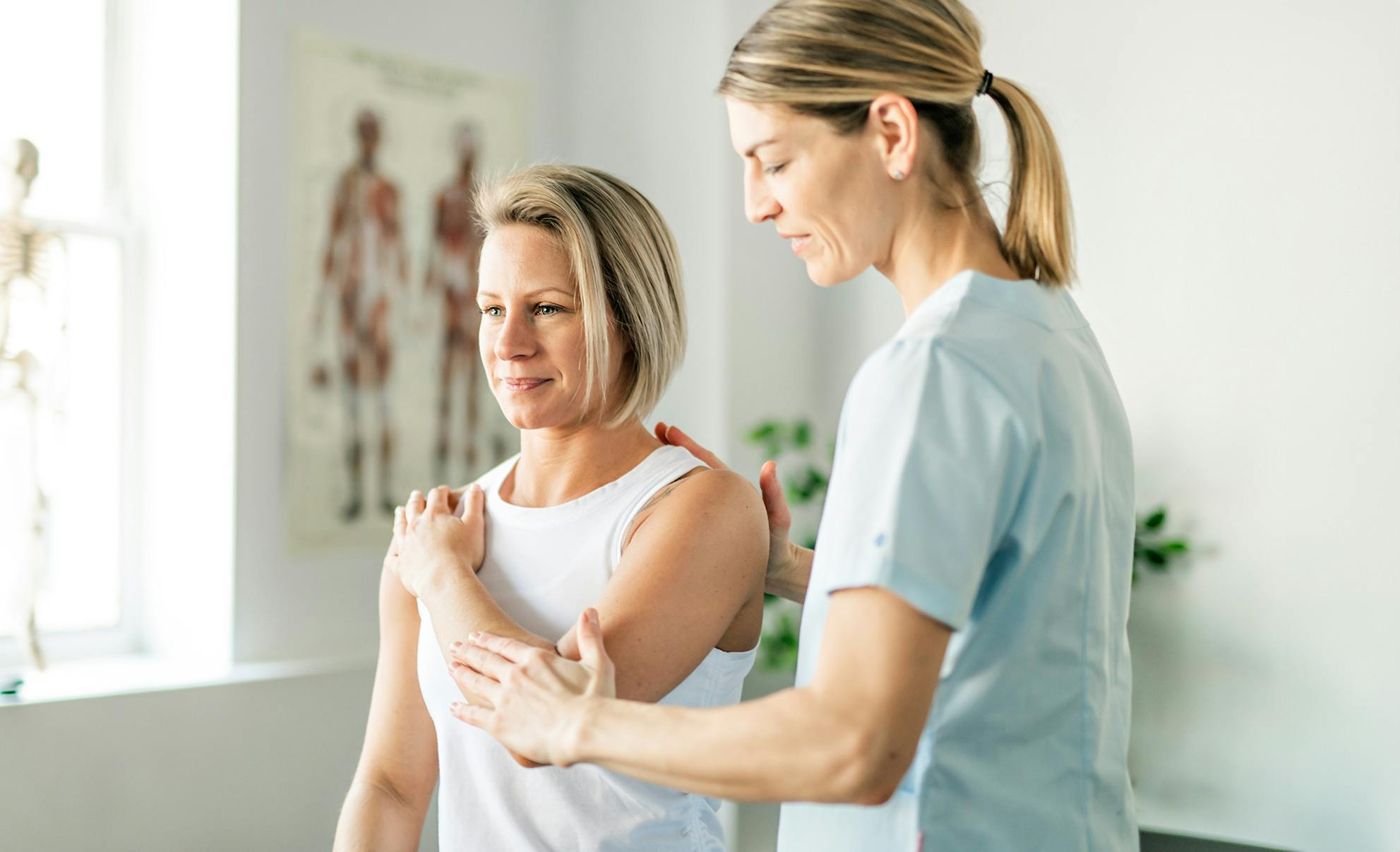 woman touching her shoulder