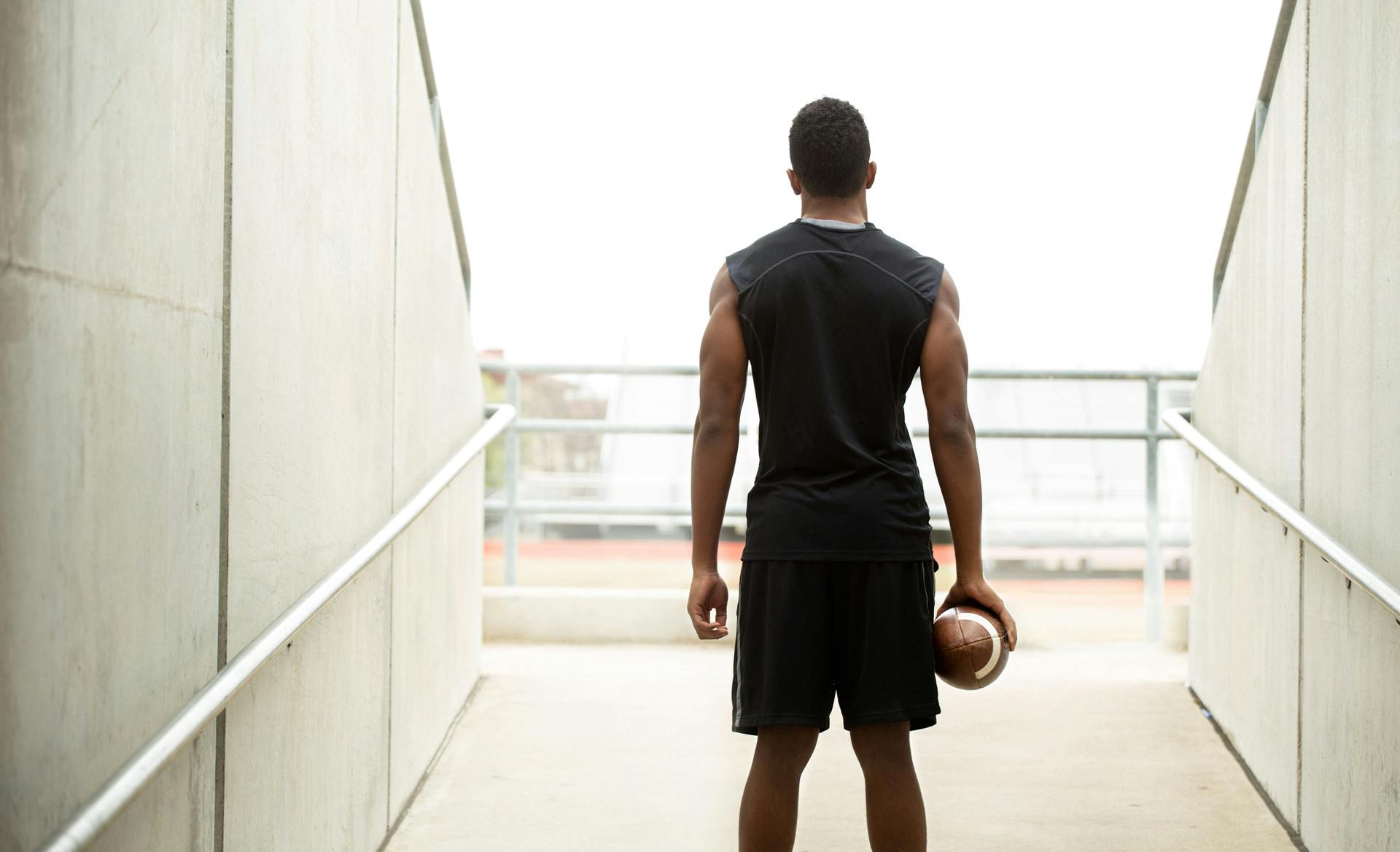 man standing looking at field