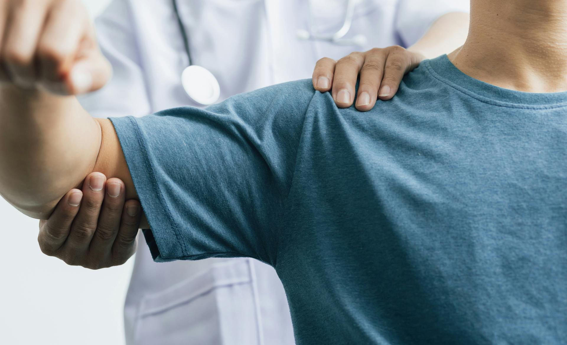 doctor moving patient's arm