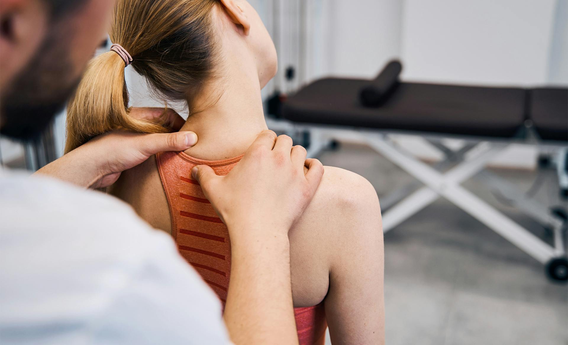 doctor massaging woman's neck