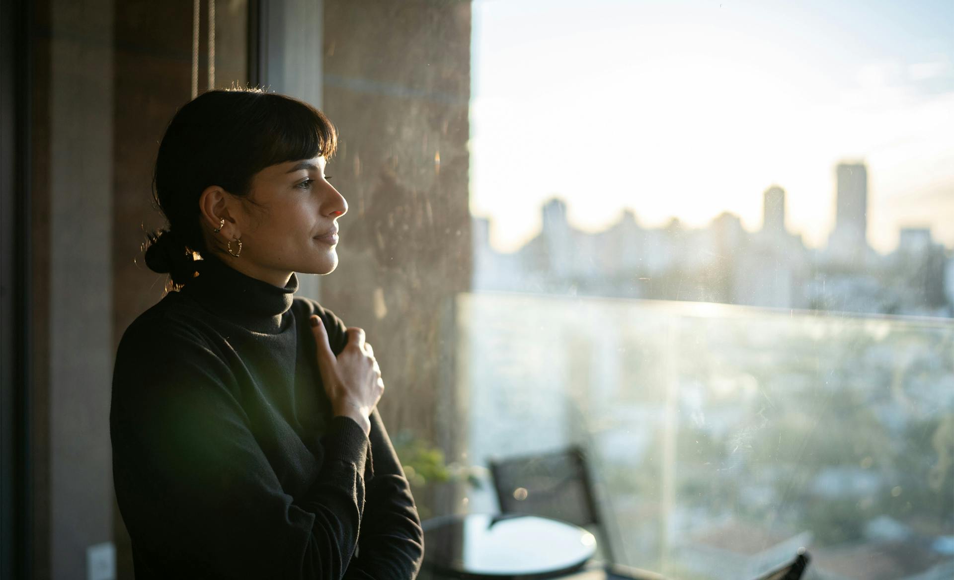 woman looking out building window