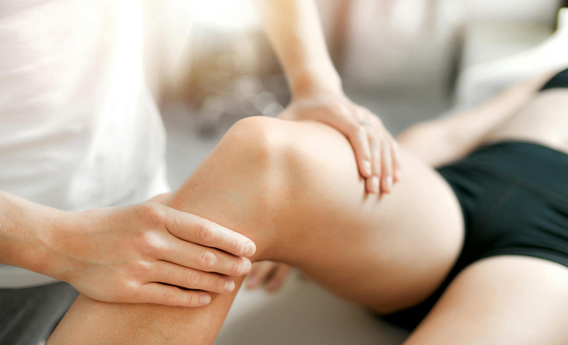 doctor holding patient's knee