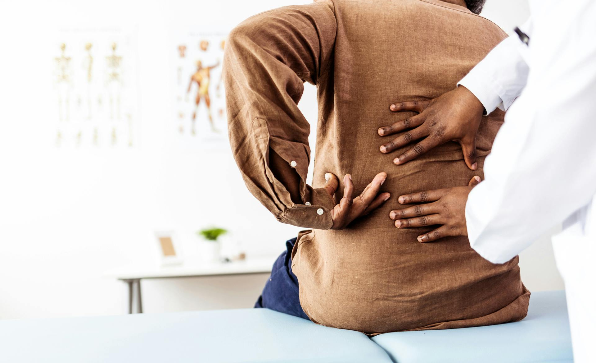 doctor checks on patient's back