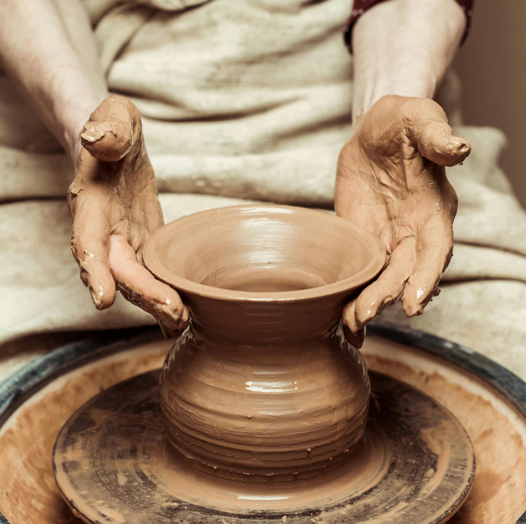 person making pottery