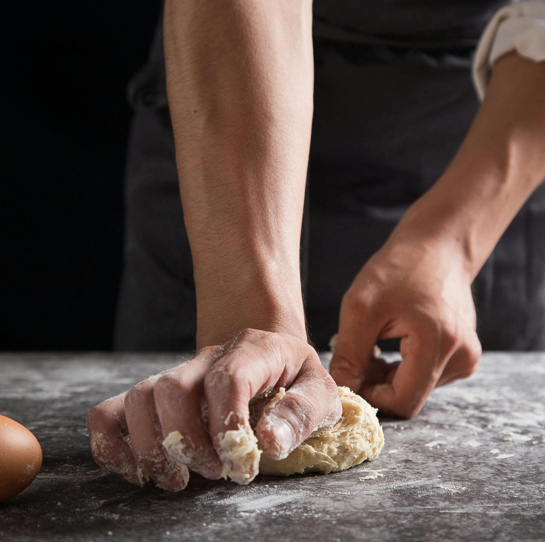 man kneading dough