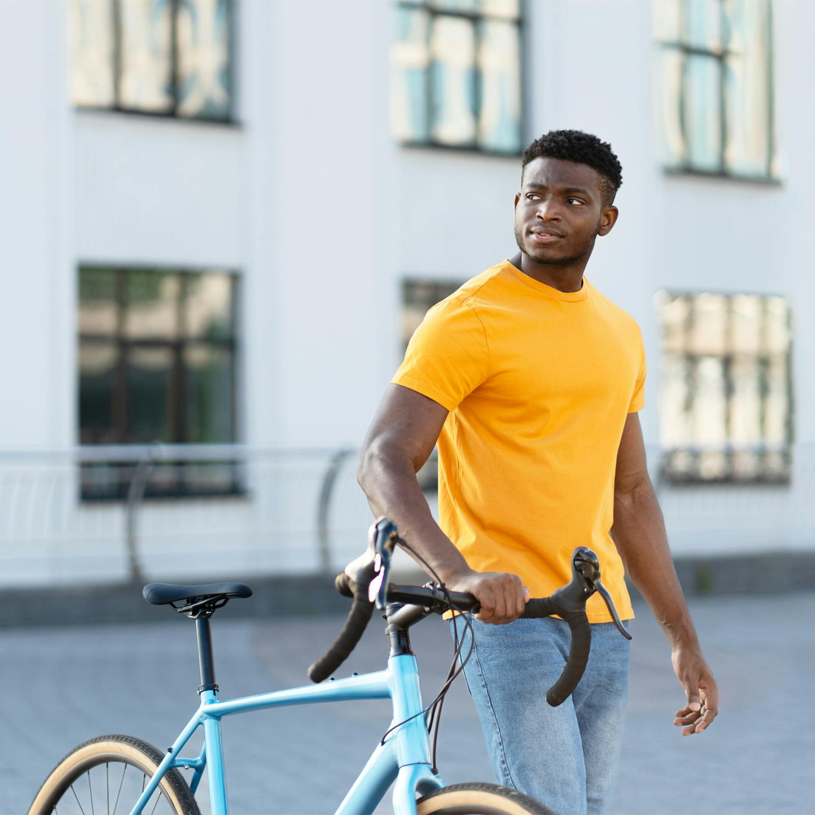 man standing with bike