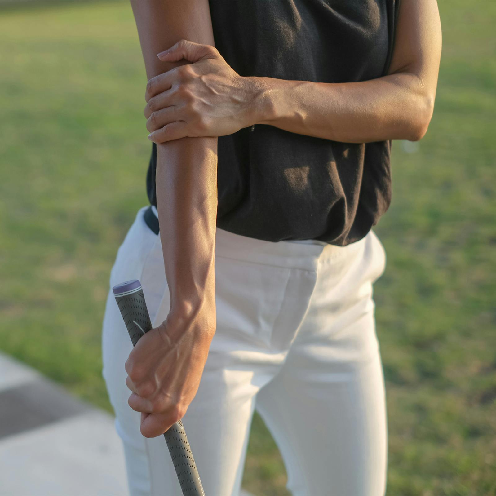person holding elbow