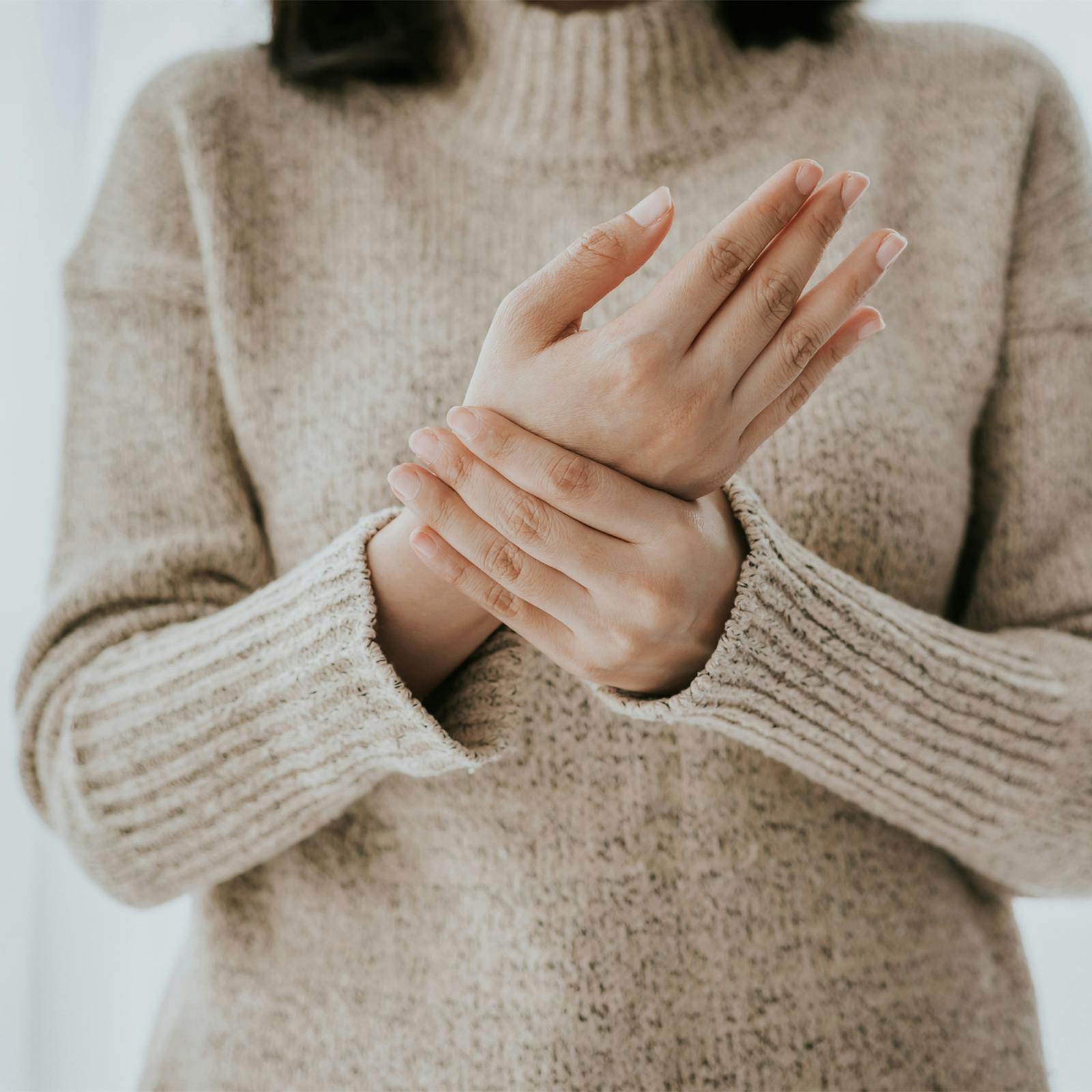 woman holding painful wrist