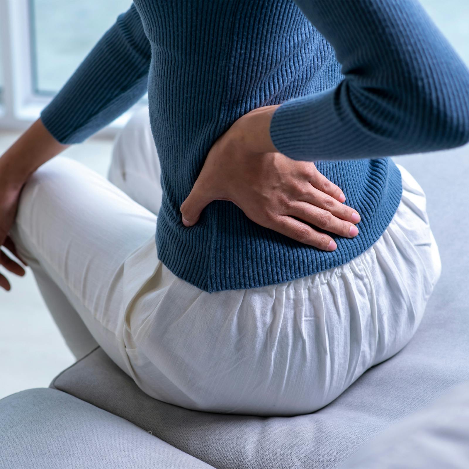 torso of woman holding hip