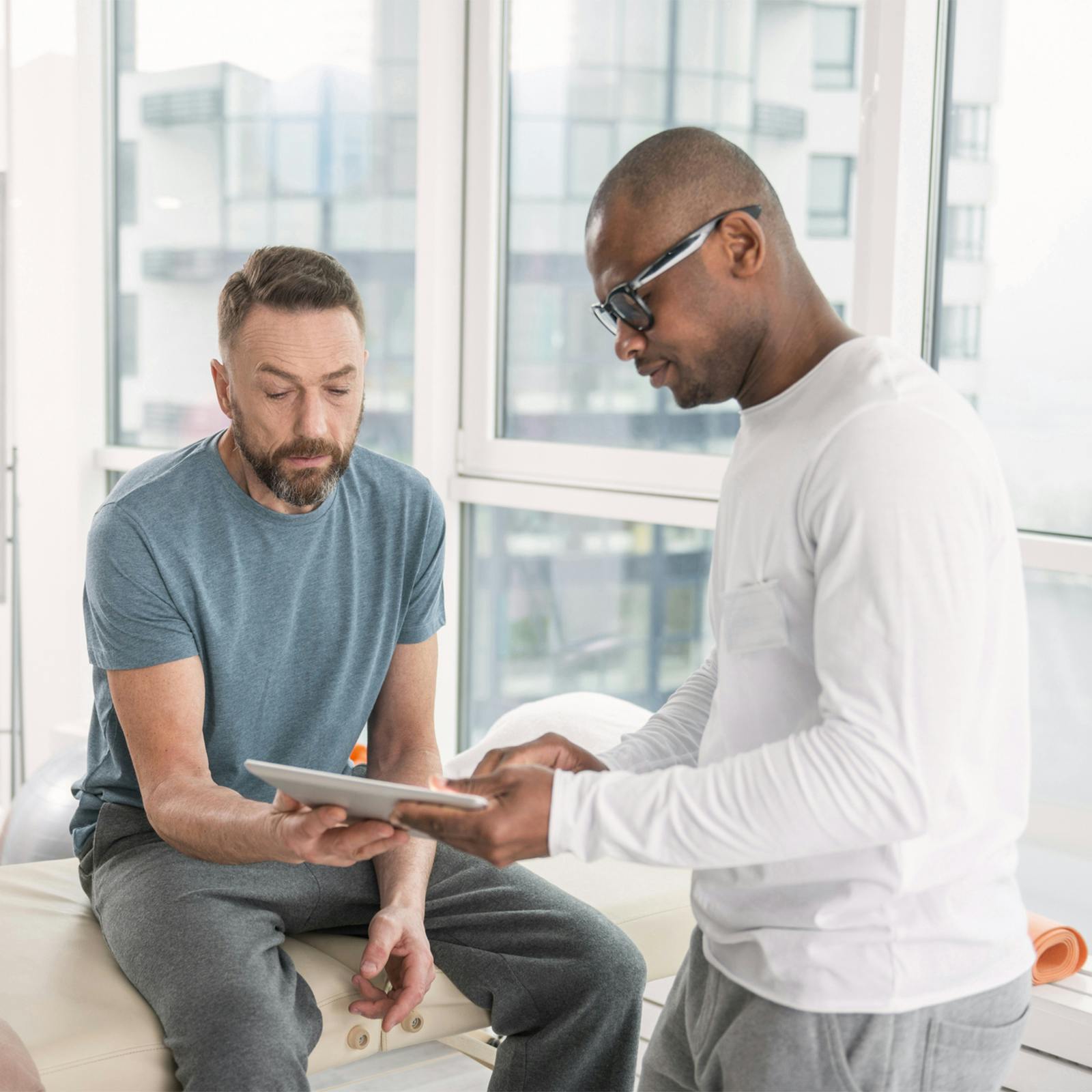 two men looking at tablet