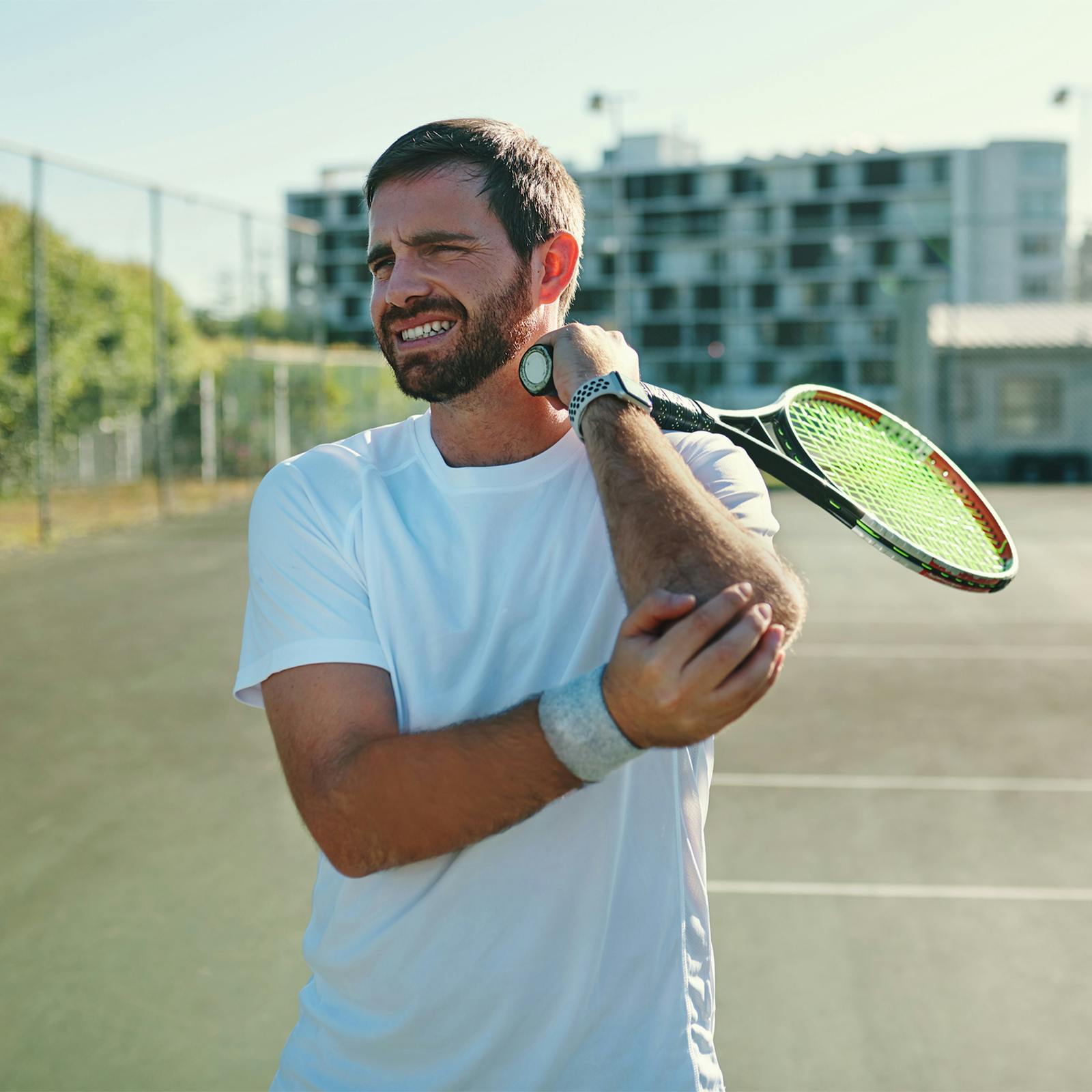 man holding elbow
