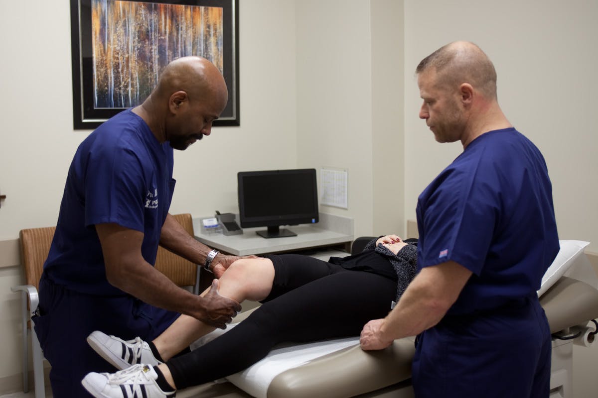 doctors addressing patient's knee