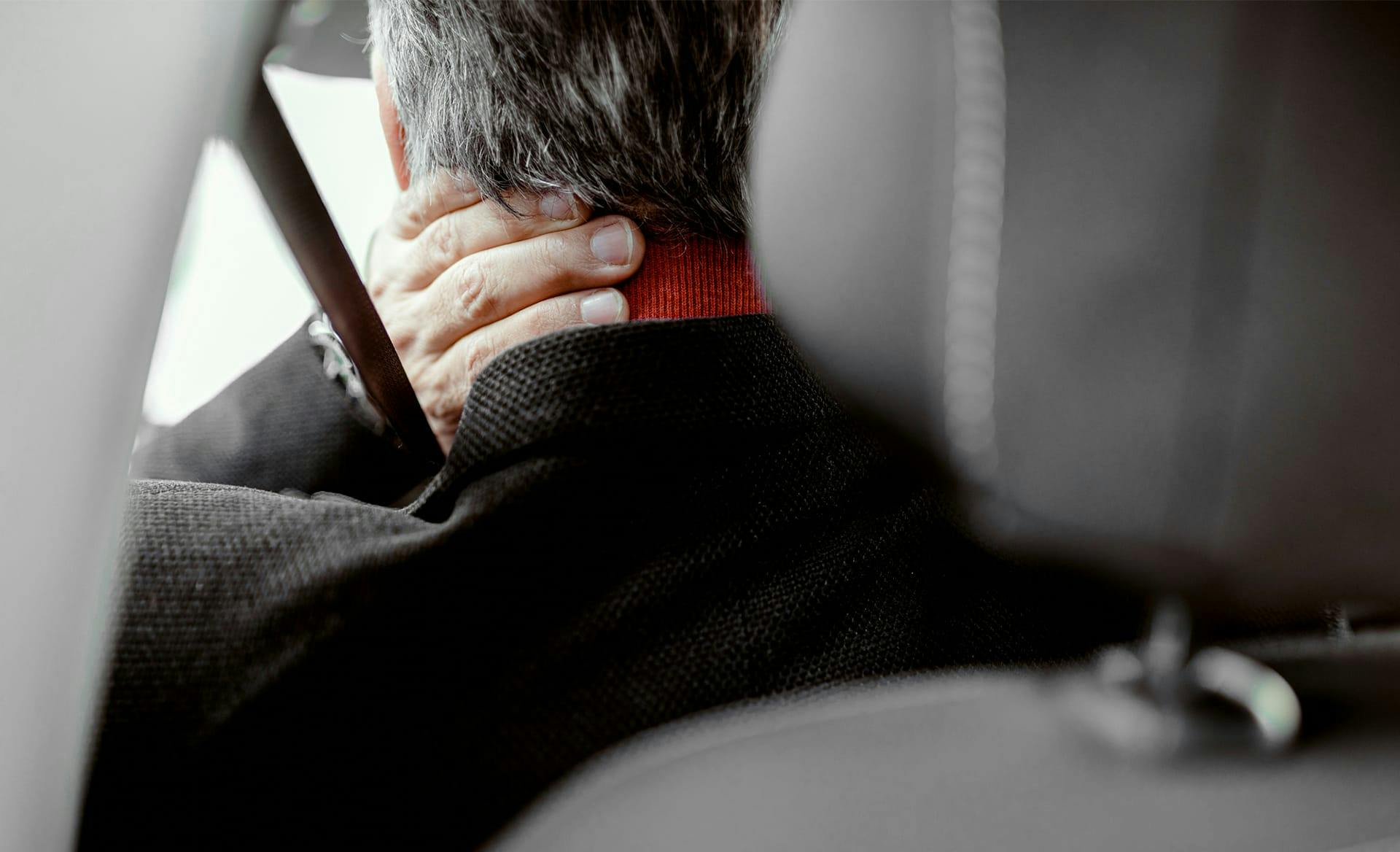 person holding next sitting in driver's seat