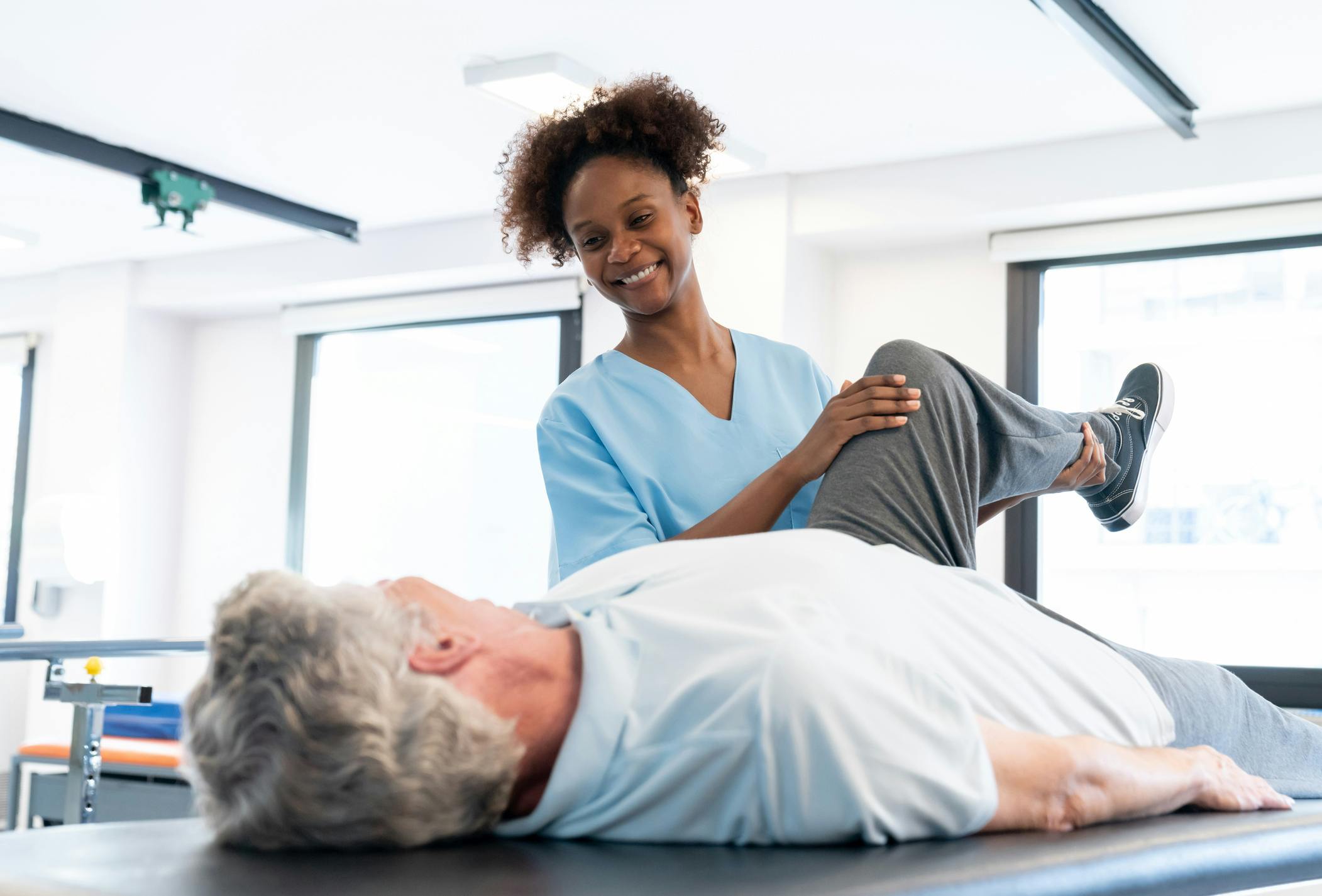 Doctor stretching a patients leg