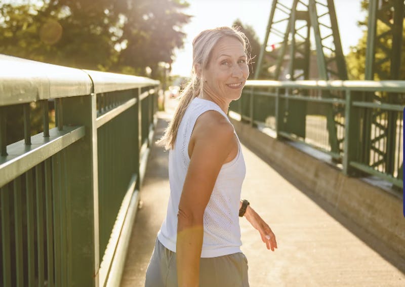 Women walking on a sidewalk looking over her shoulder