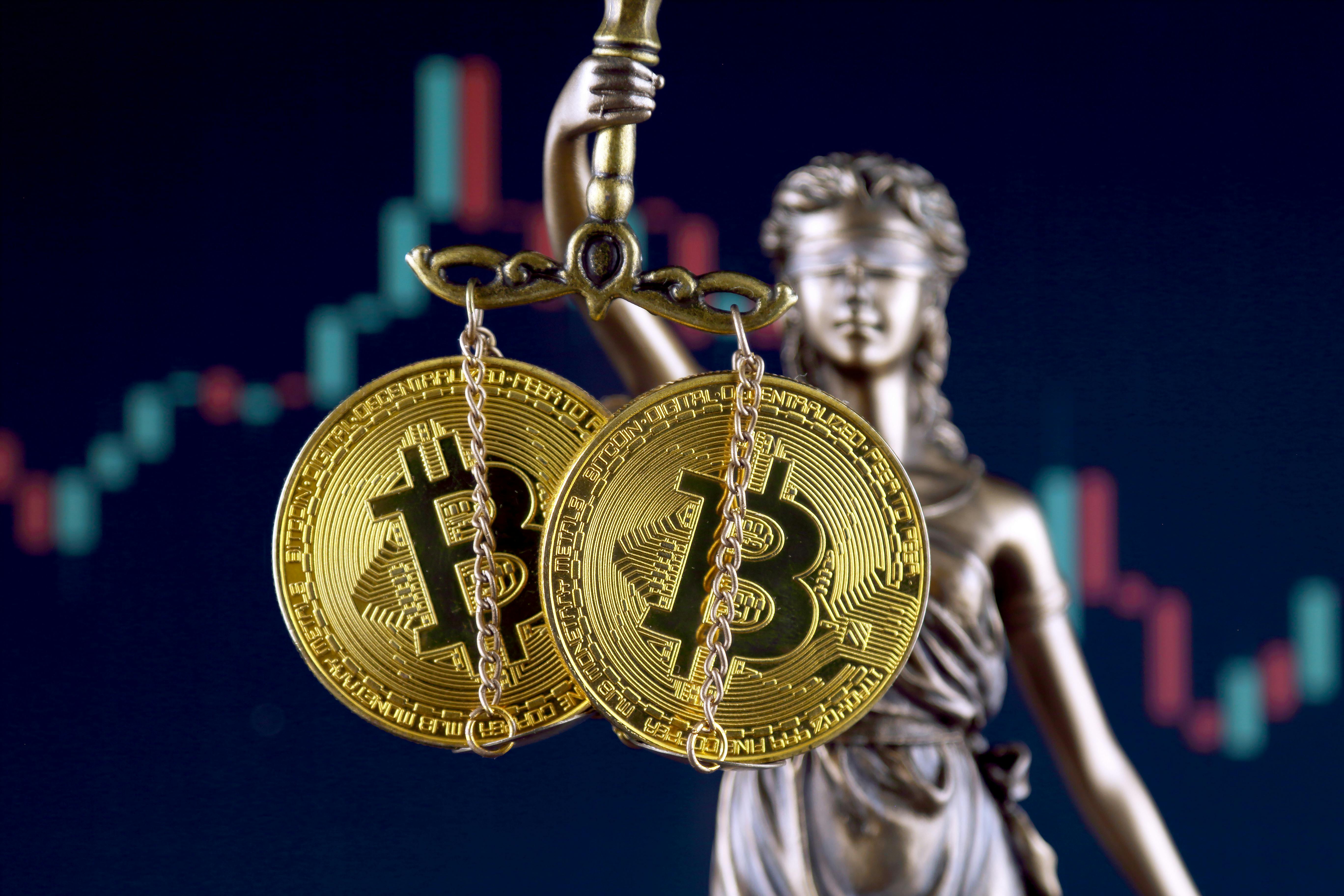 Justice holding scales of Bitcoin