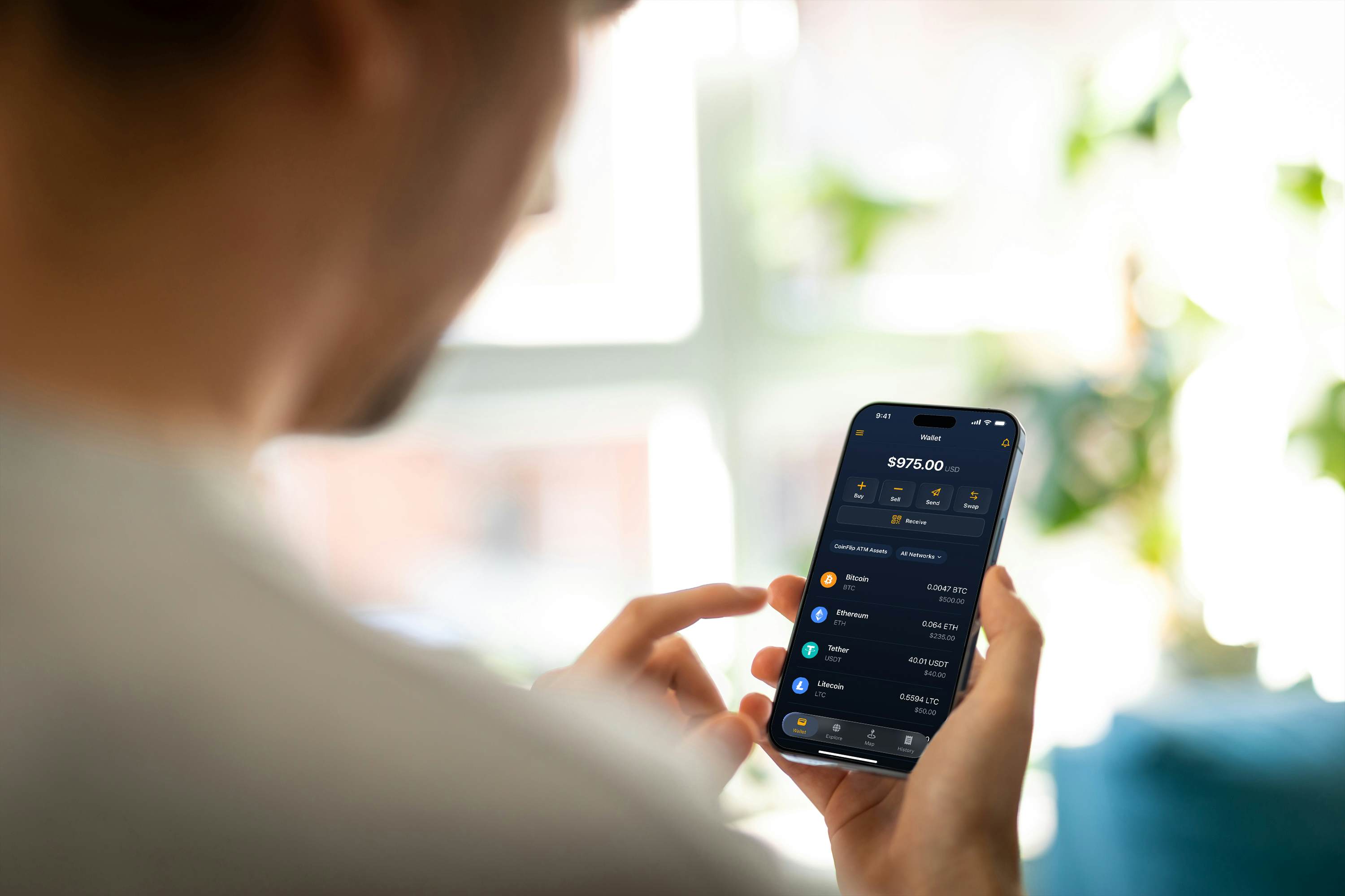 Person with phone using CoinFlip Wallet app