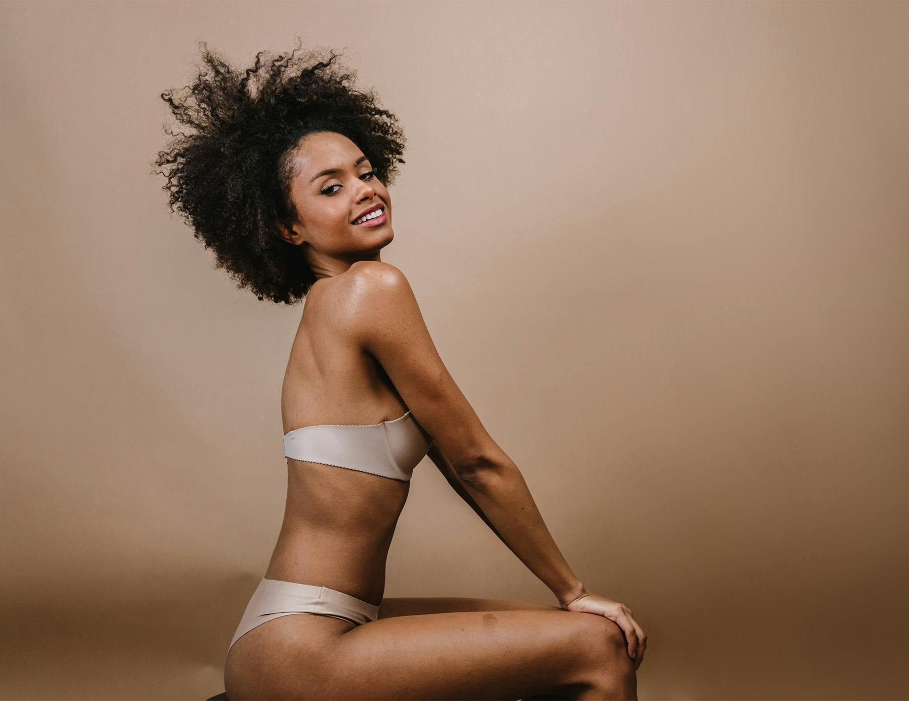 sitting playful beige backdrop