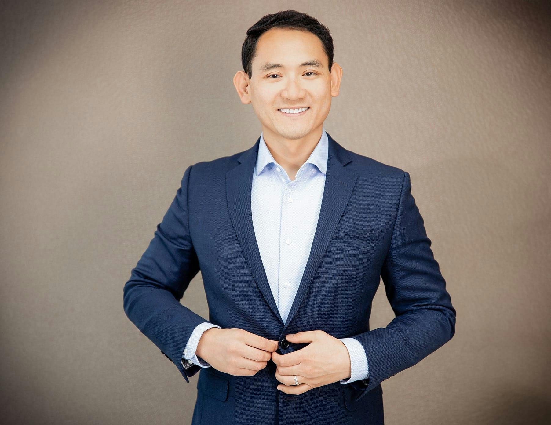 Dr. Frank Yuan buttoning jacket
