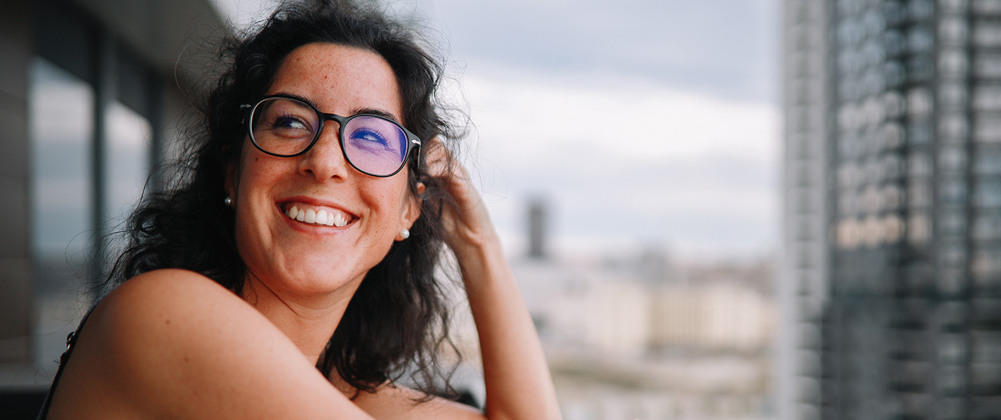 Smiling woman with buildings in background