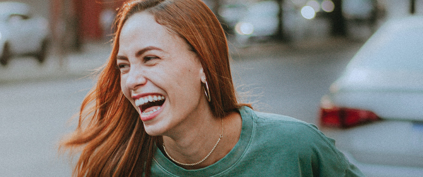 Young woman with red hair laughing