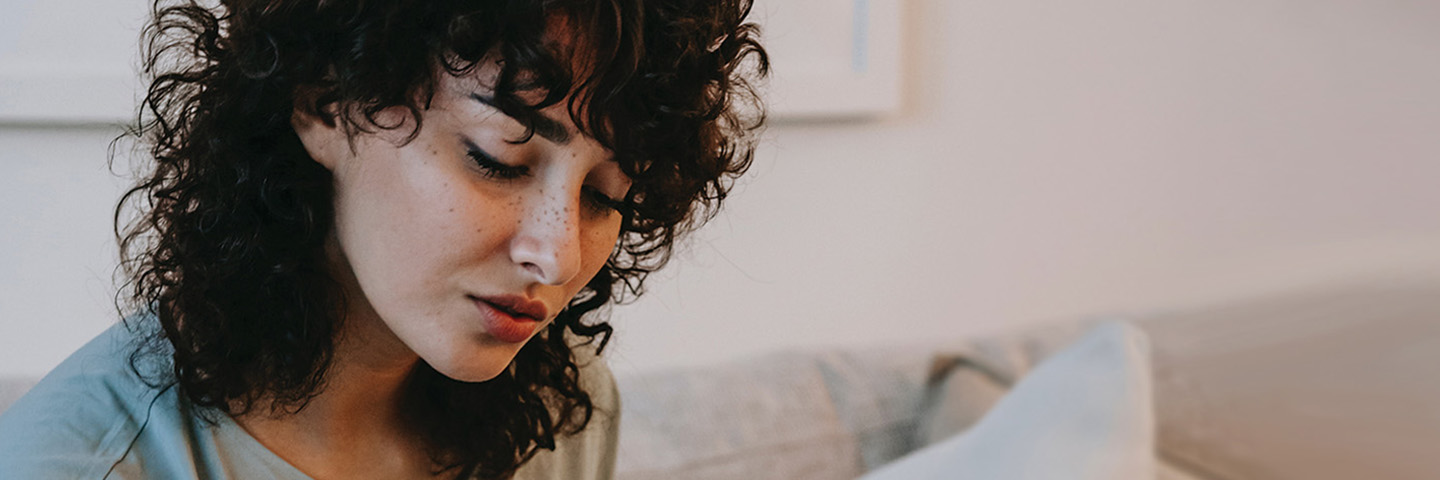 Woman on couch reading