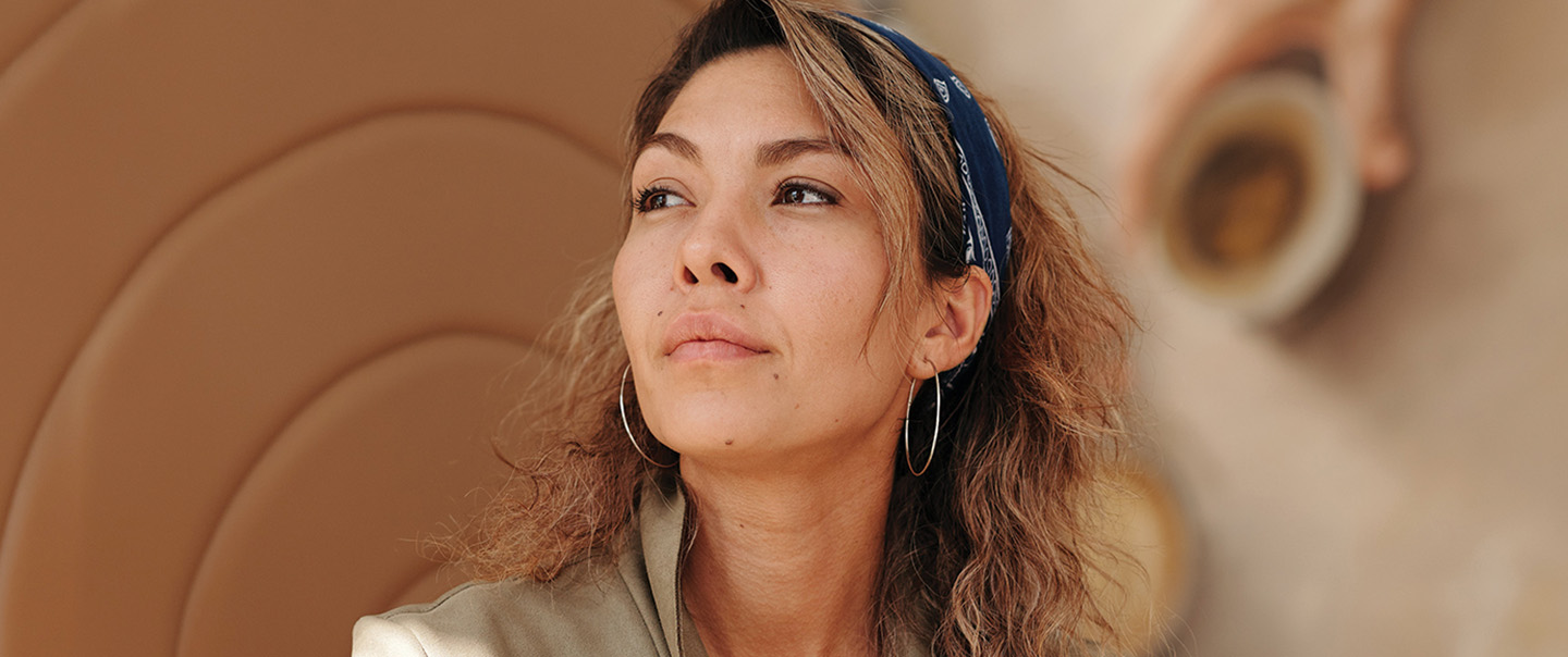 Woman with headband and large hoop earrings
