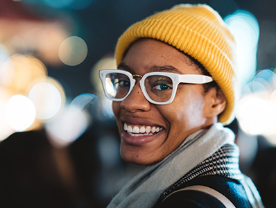 Woman with a yellow beanie and white glasses