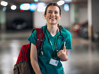 Woman in hospital uniform with backpack