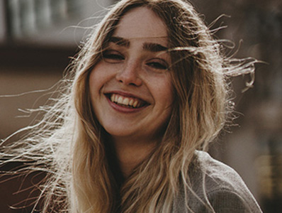 Young woman with hair blowing in wind