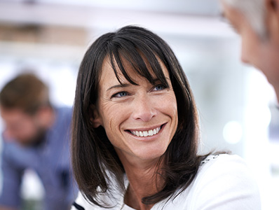 Woman smiling having a workplace conversation