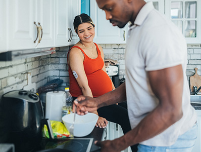 Man and woman in kitchen cooking