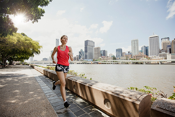 Woman jogging next to a river